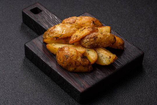 Fried potato wedges seasoned with salt and spices, ready for dinner table. Fried potato wedges