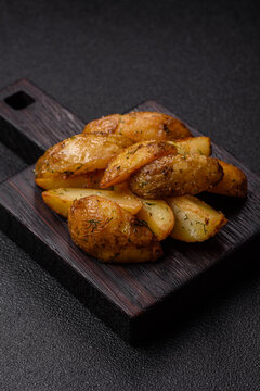 Fried potato wedges seasoned with salt and spices, ready for dinner table. Fried potato wedges