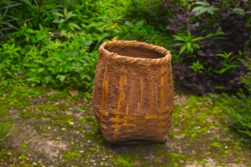 Naklejka premium Traditional Woven Bamboo Basket in a Rural Garden