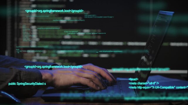 Programmer's hands and laptop keyboard close-up. The developer writes the application code