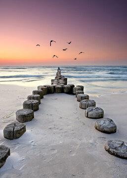 idyllic Baltic Sea Beach with a Long Weathered Wooden Pier