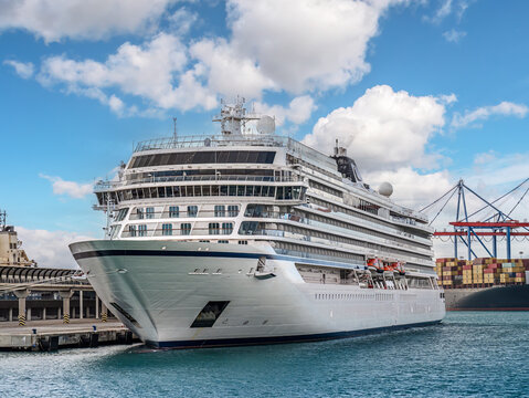 Luxury Cruise Ship Docked at Port under Blue Sky