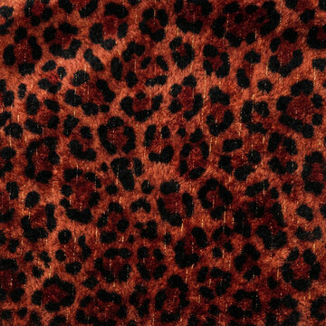 Leopard print pattern textured fabric background featuring fuzzy brown and black fur spots with shimmering gold metallic thread accents throughout