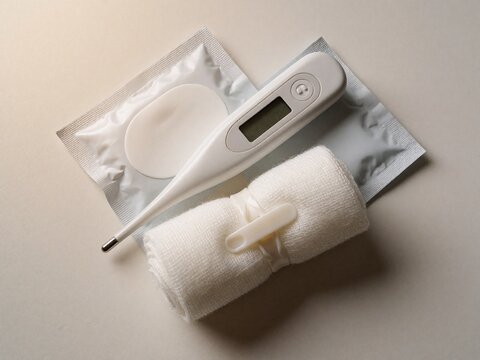 Medical supplies flat lay with thermometer bandage and patch