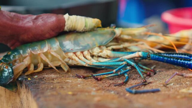 Cutting process of giant freshwater Rosenberg shrimp lat. Macrobrachium rosenbergii at fish market, seafood cutting process slow motion