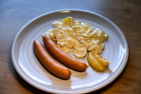 Bockwurst with potato salad and mustard. Lunch, dinner, kitchen, sausage, meal, restaurant, mayonnaise, table.