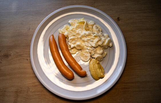 Bockwurst with potato salad and mustard. Lunch, dinner, kitchen, sausage, meal, restaurant, mayonnaise, table.