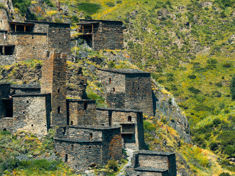 Aerial view of the historic medieval village of Mutso with its ancient stone towers and slate buildings nestled on the rugged mountain slopes in Mutso, Mtskheta-Mtianeti, Georgia.