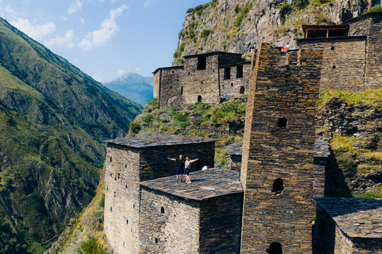 Aerial view of the historic medieval village of Mutso with ancient stone towers and fortifications perched on a steep mountain slope, Mutso, Mtskheta-Mtianeti, Georgia.