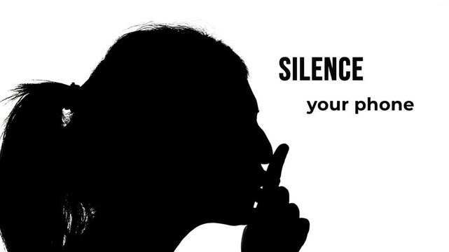 Black and white silhouette of woman making shushing gesture with finger to lips in profile view. Silence your phone text appears. Minimalist monochrome cinema etiquette announcement.
