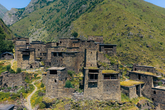 Aerial view of the historic stone towers and fortifications of Shatili village nestled in the mountains, featuring traditional medieval architecture in Shatili, Mtskheta-Mtianeti, Georgia.