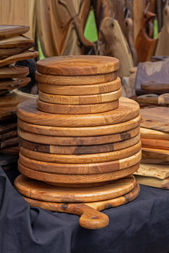 Homemade traditional art and craft wooden cutting boards sold on market stall