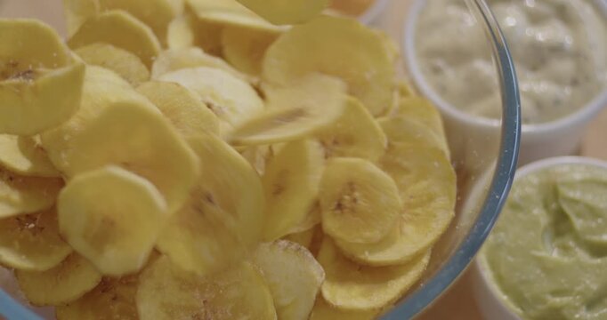 Slow Motion Video of Plantain Chips Falling into a Bowl - Dynamic Snack Footage