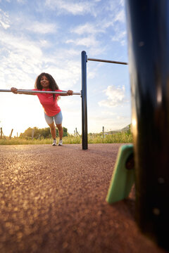 Woman doing push up exercise at outdoor gym during sunrise