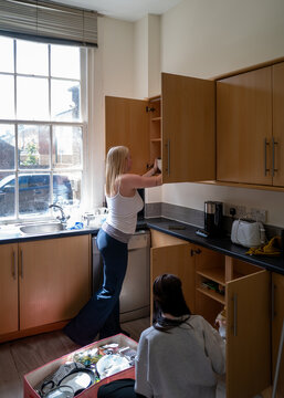 Gen Z girls unpacking their belongings into their first flatshare