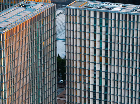 Aerial view of modern office buildings with grid-like facades and vertical stone fins in the EUR district of Rome, Lazio, Italy.