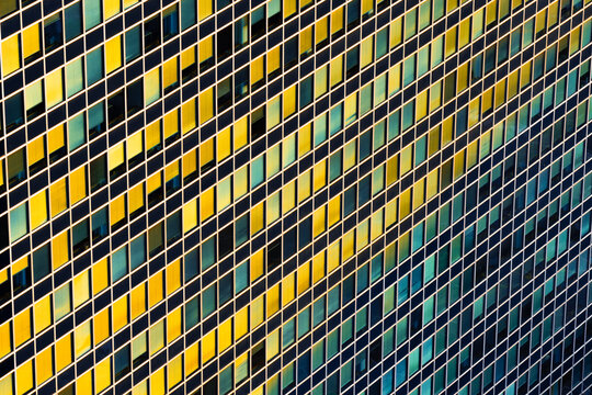 Aerial view of the modern office building facade in the EUR district with its distinctive grid of windows reflecting golden sunlight in Rome, Lazio, Italy.