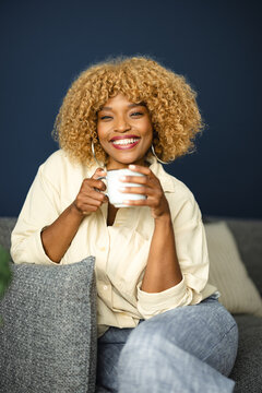 Woman Drinking Coffee in Cozy Setting With Soft Colors