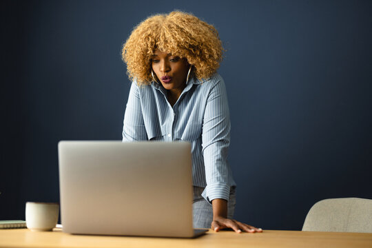 Woman Working at a Laptop in an Office Setting