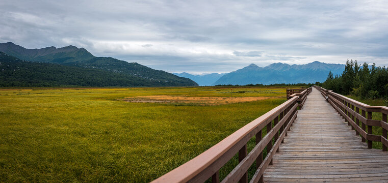 Alaska summer panoramic landscape at Potter Marsh Wildlife Refuge boardwalk with view of Chugach Mountains and Rabbit Creek in Anchorage USA