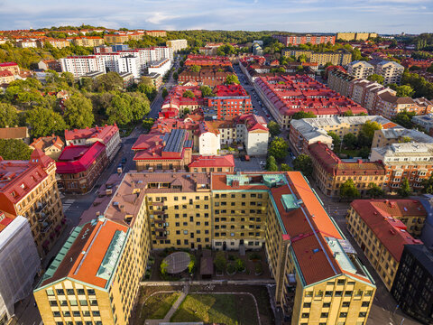 Aerial view of residential buildings with red roofs and urban streets in Gothenburg, Vastra Gotaland Count, Sweden.