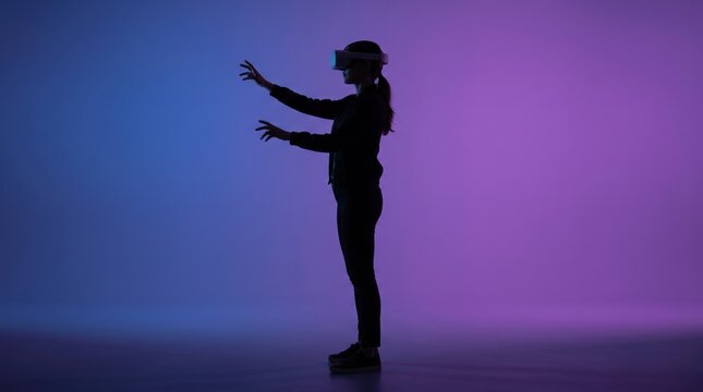 Silhouette of woman wearing virtual reality headset interacting with digital content against purple and blue gradient, immersive technology experience, futuristic metaverse