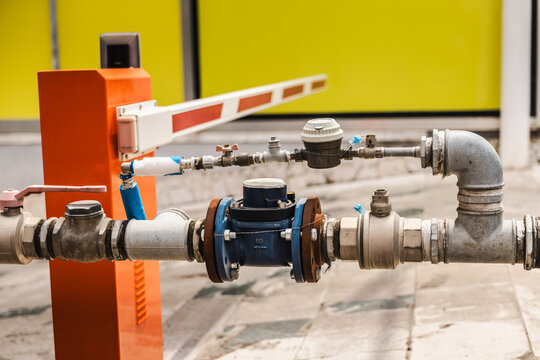 Industrial Pipe Valve Assembly Beside Access Barrier