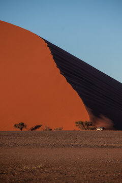 vertical Safari vehicle exploring Namib desert dunes