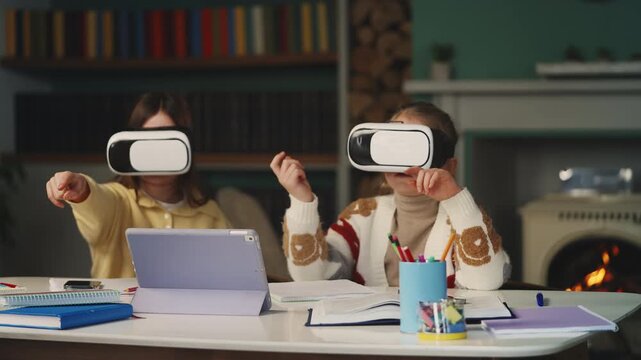 Two girls use VR headsets for interactive learning at home, digital education
