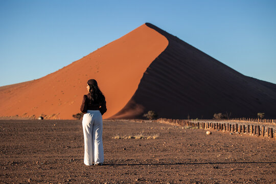 Woman admiring Dune 45 in Namib-Naukluft National Park, Namibia