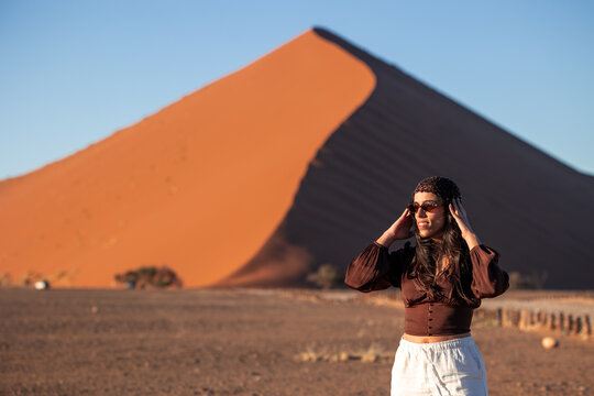 Woman enjoying Namibia desert landscape at Sossusvlei dune