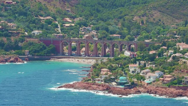 View of red coast beach with bridge drone video Cap Roux France 4K