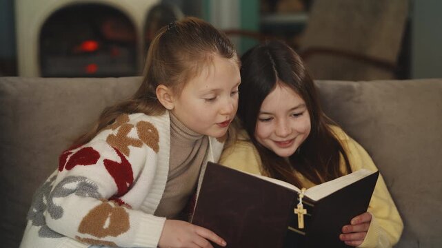 Two sisters read the Bible with prayer beads together, spiritual education