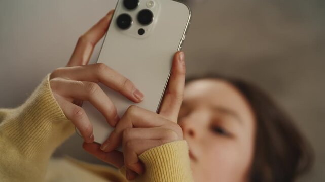 Girl scrolls through social media app on phone, reduced attention span concept