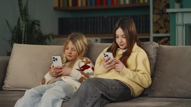 Two girls immersed in their phones, social media addiction concept