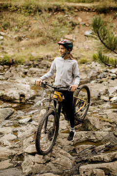 Exploring a rocky stream with a mountain bike in serene nature