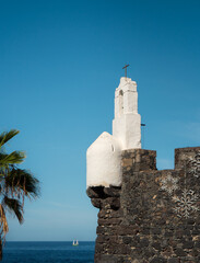 Fototapeta premium White chapel tower of Castillo de San Miguel, a 16th century fortress safeguarding the maritime and defensive history of the picturesque village of Garachico, Tenerife, Canary Islands