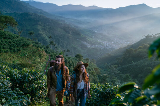 Hikers Trekking Through Lush Mountain Valley at Morning