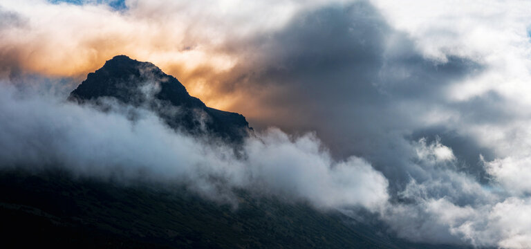 Dramatic sunrise cloudscape over the Chugach Mountains summit glacial rock formation in Anchorage Alaska viewed from Glen Alps Hiking Trail