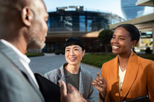 Business professionals networking outdoors at modern office