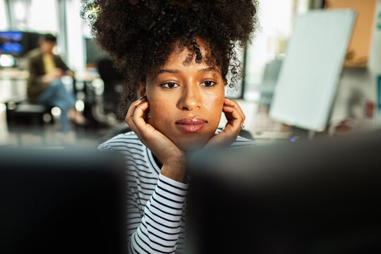 Focused woman working at computer in modern office