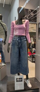 Escaparate con maniqu&iacute; con ropa femenina estilo denim, con su&eacute;ter rosa, pantalones vaqueros y zapatillas deportivas en tienda de ropa Boxeur des Rues en Madrid, Espa&ntilde;a, 11 de junio de 2026