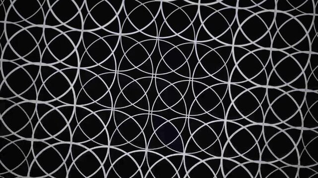 White overlapping circles pattern on black background, representing abstract design, minimal geometry, and modern motion graphic overlay.