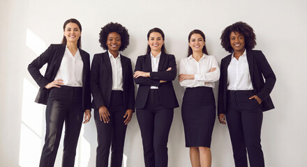 Obraz premium Group of diverse professional women standing together in business suits