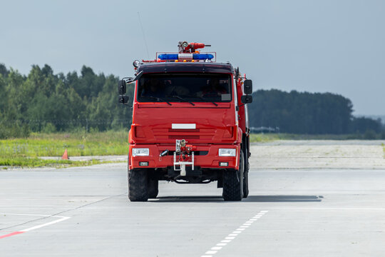 Front view of the red airfield fire engine truck at the airport
