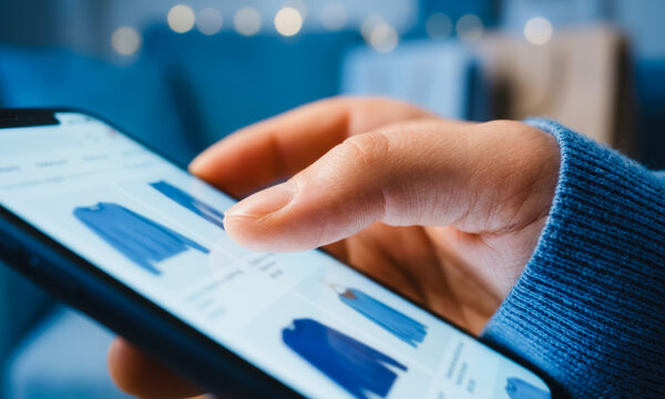 Person using a smartphone to shop for clothing online
