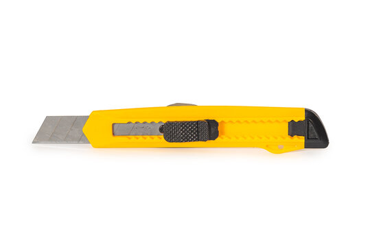 Yellow stationery knife with retractable blade isolated on white background. Retro stationery.