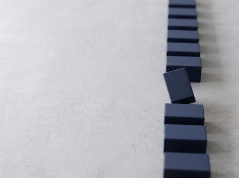 Minimalist 3D Render of Blue Geometric Modules on Concrete, Highlighting a Single Deviant Block in a Process Sequence