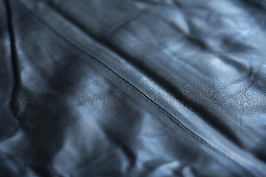 black leather texture close-up, seams on leather jacket as background, black natural leather as background, black leather stitching	

