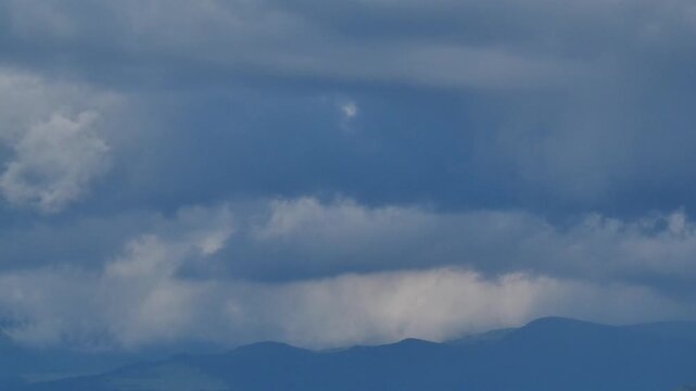 Distant Blue Mountain Ranges and Cumulus Clouds